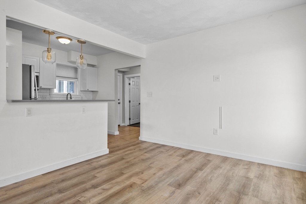300 Marginal Street, Unit 3 Boston, MA 02128 - Photo 7 of 19 a view of a kitchen with wooden floor and a sink