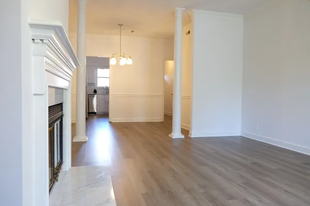 a view of a hallway with wooden floor