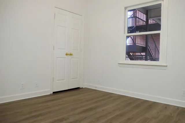 an empty room with a painting on the wall