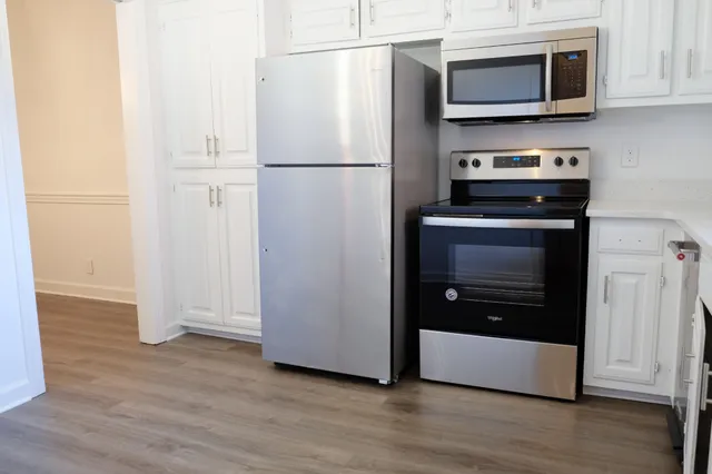 a kitchen with stainless steel appliances a refrigerator stove and microwave