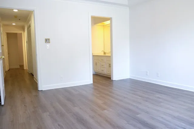 an empty room with wooden floor and a window