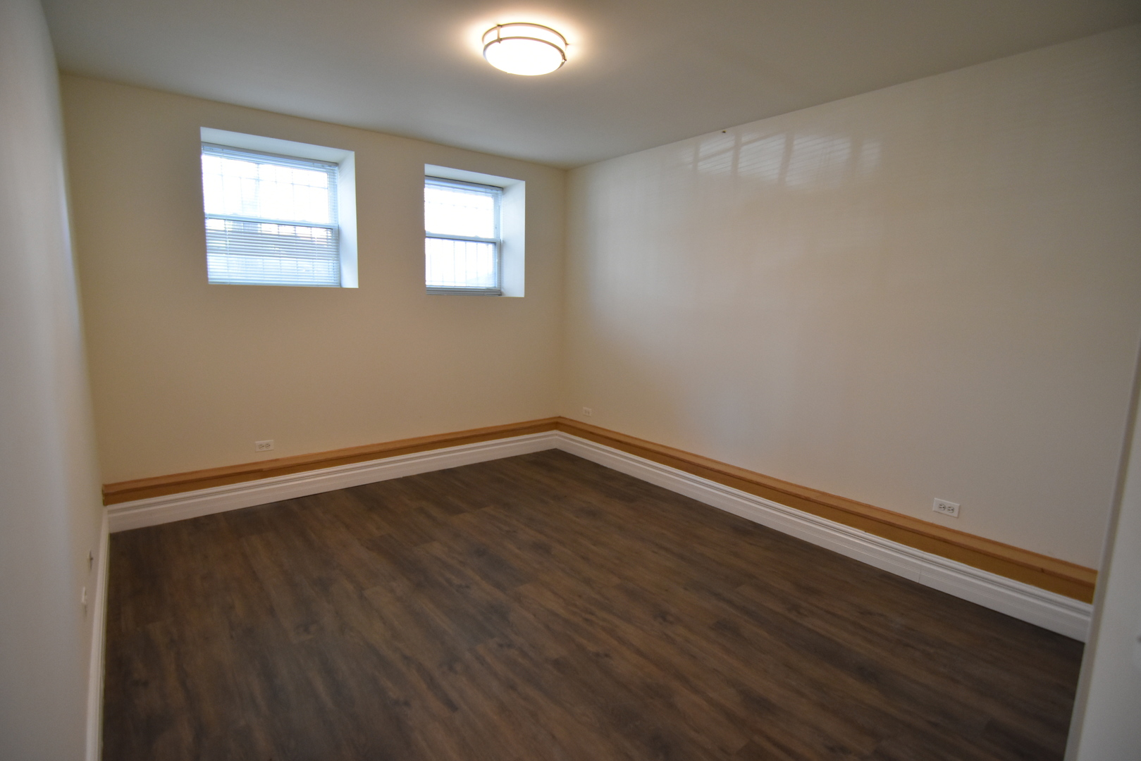 953 West Fletcher Street, Unit 1 Chicago, IL 60657 - Photo 13 of 23 a view of an empty room with wooden floor and a window