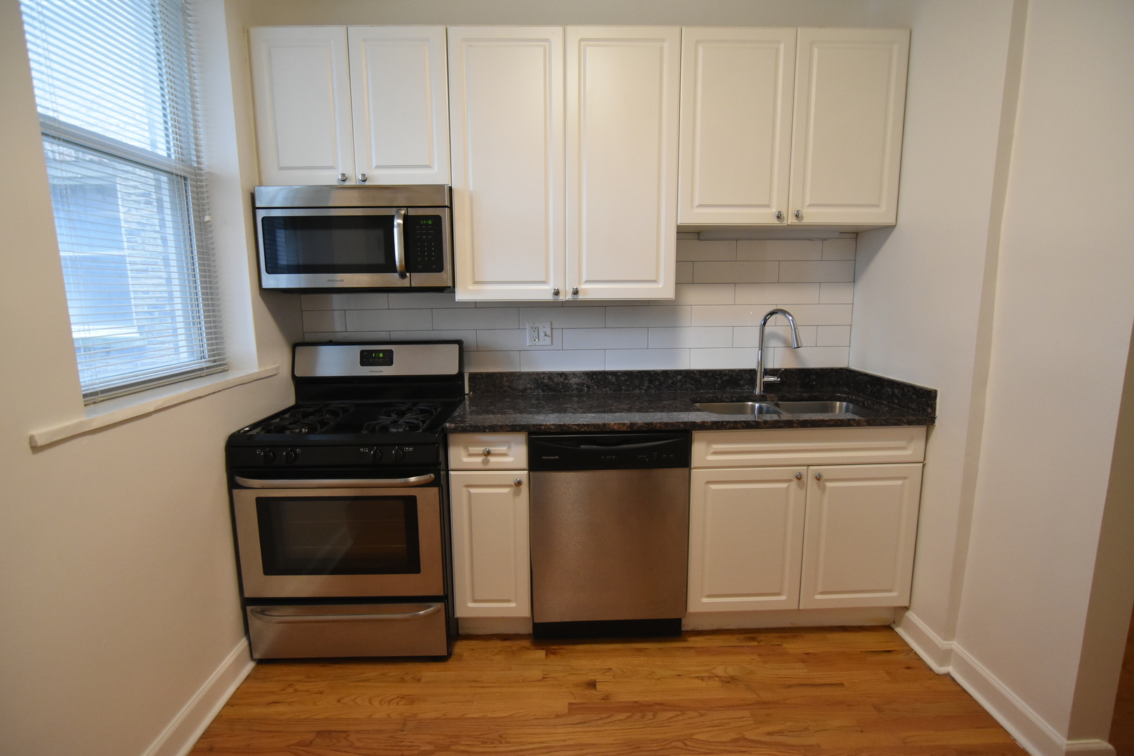 953 West Fletcher Street, Unit 1 Chicago, IL 60657 - Photo 4 of 23 a kitchen with white cabinets and appliances