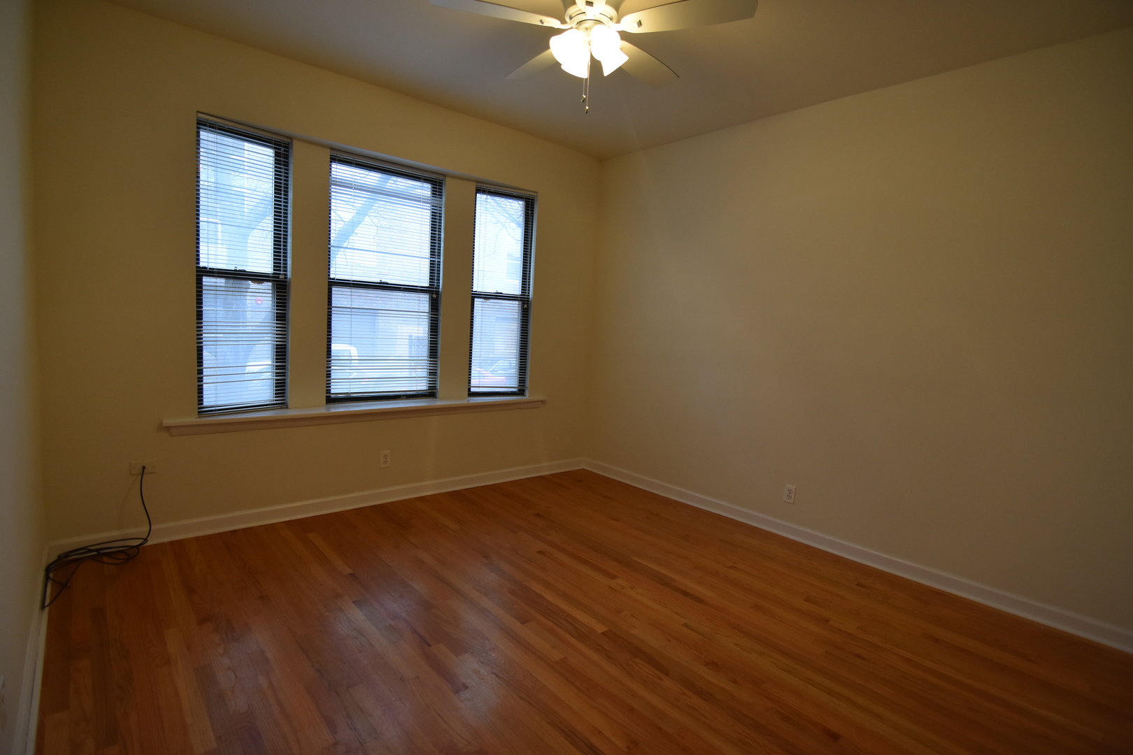953 West Fletcher Street, Unit 1 Chicago, IL 60657 - Photo 8 of 23 a view of an empty room with wooden floor and a window