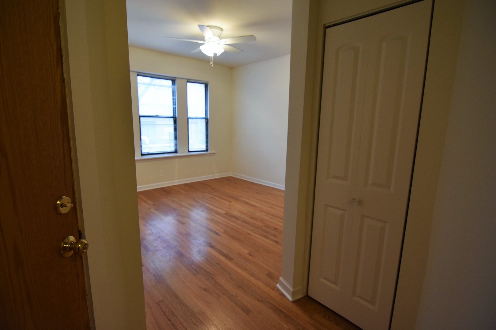 953 West Fletcher Street, Unit 1 Chicago, IL 60657 - Photo 9 of 23 wooden floor in an empty room with a window