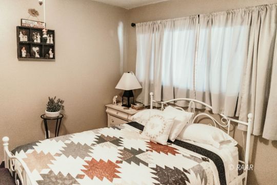 428 Peg Street Ridgecrest, CA 93555 - Photo 22 of 29 a bedroom with a bed and a table