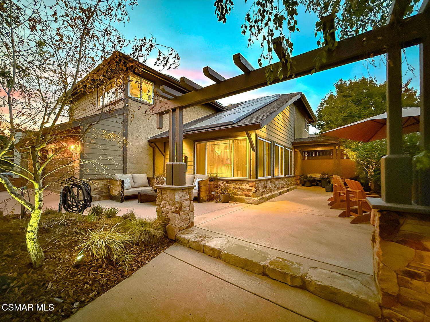 a view of a backyard with table and chairs and a barbeque