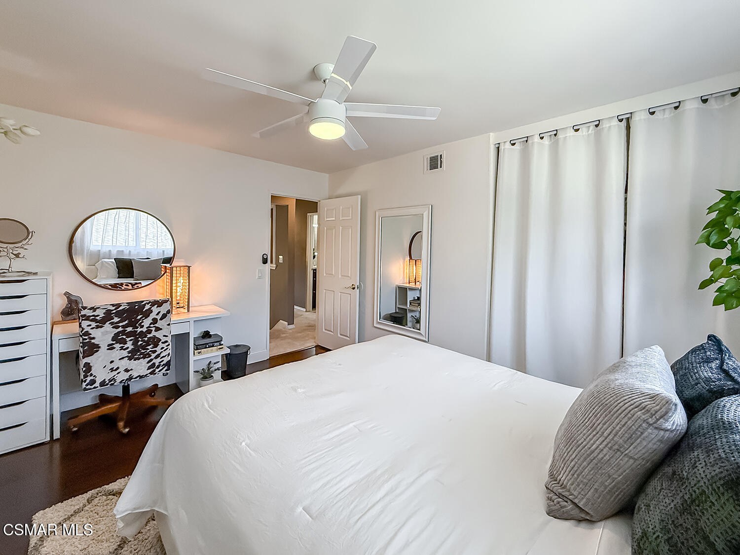 4581 Lubbock Drive Simi Valley, CA 93063 - Photo 29 of 53 a spacious bedroom with a bed a mirror and a chandelier
