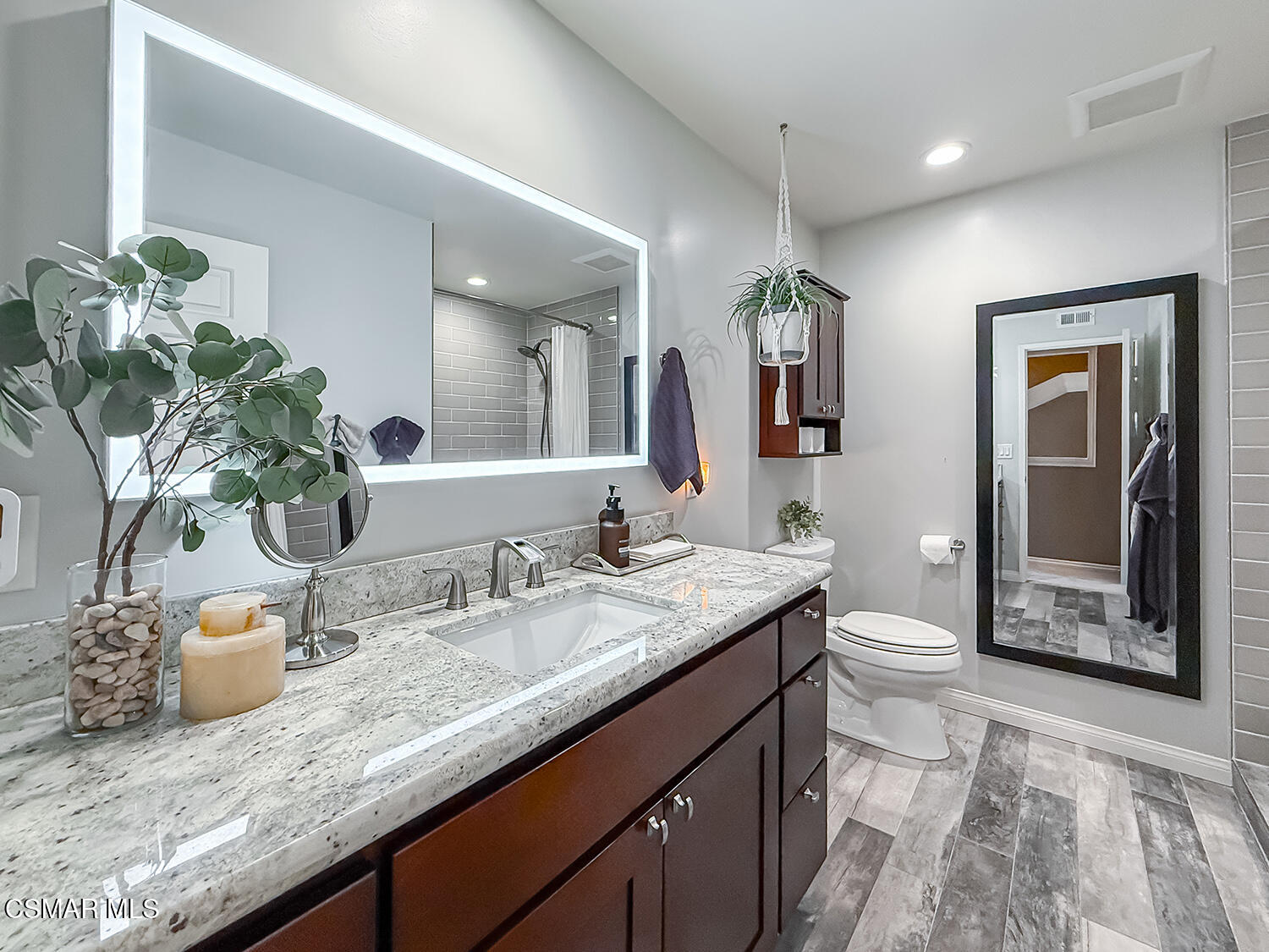 4581 Lubbock Drive Simi Valley, CA 93063 - Photo 30 of 53 a bathroom with a granite countertop sink a toilet and mirror