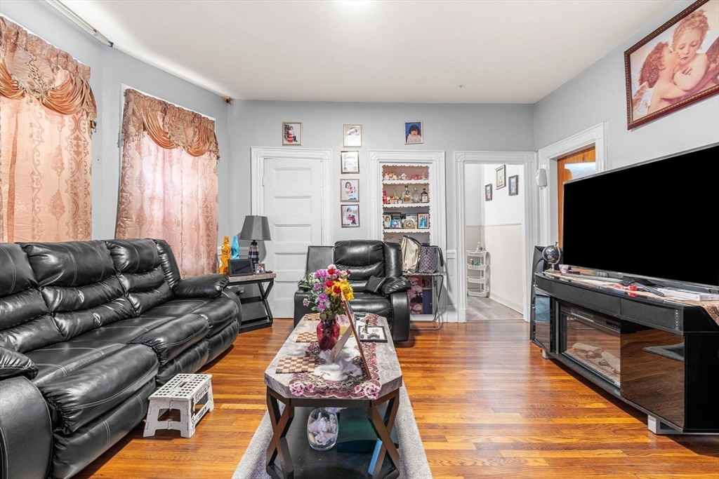 67 School Street Everett, MA 02149 - Photo 23 of 37 a living room with furniture and a flat screen tv