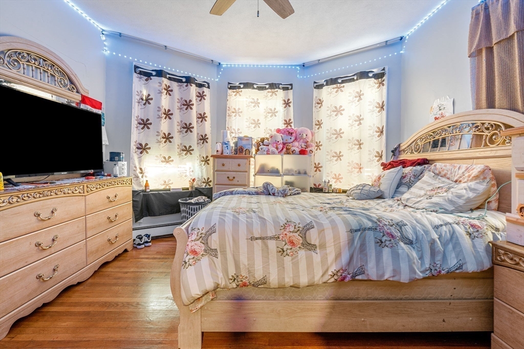 67 School Street Everett, MA 02149 - Photo 24 of 37 a bedroom with a bed and window