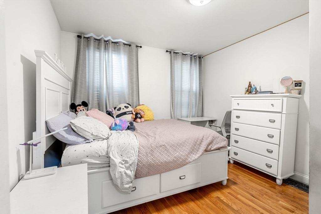67 School Street Everett, MA 02149 - Photo 7 of 37 a bedroom with a bed and wooden floor