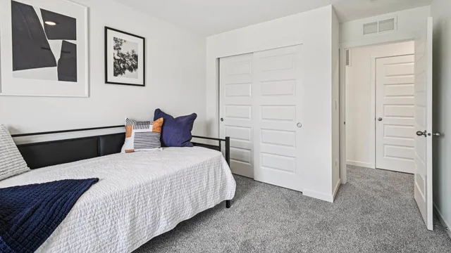 a bedroom with a bed and cabinets