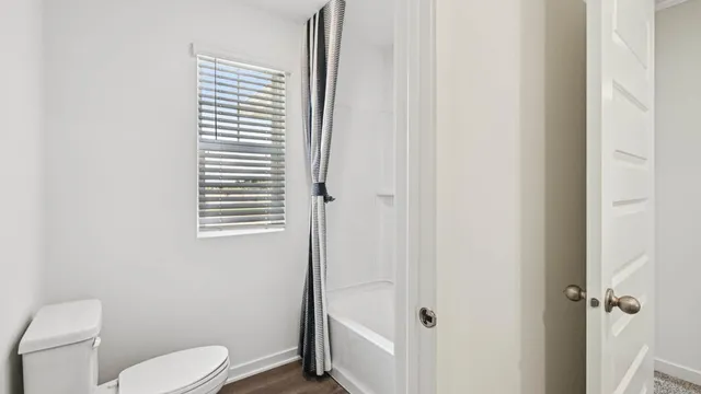 a white toilet sitting next to a bathroom sink