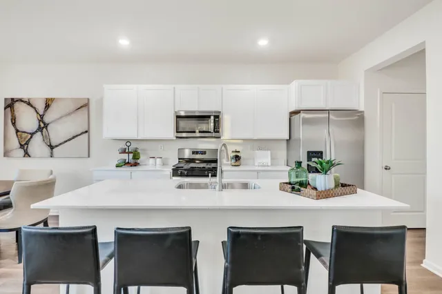 a kitchen with appliances a sink and cabinets