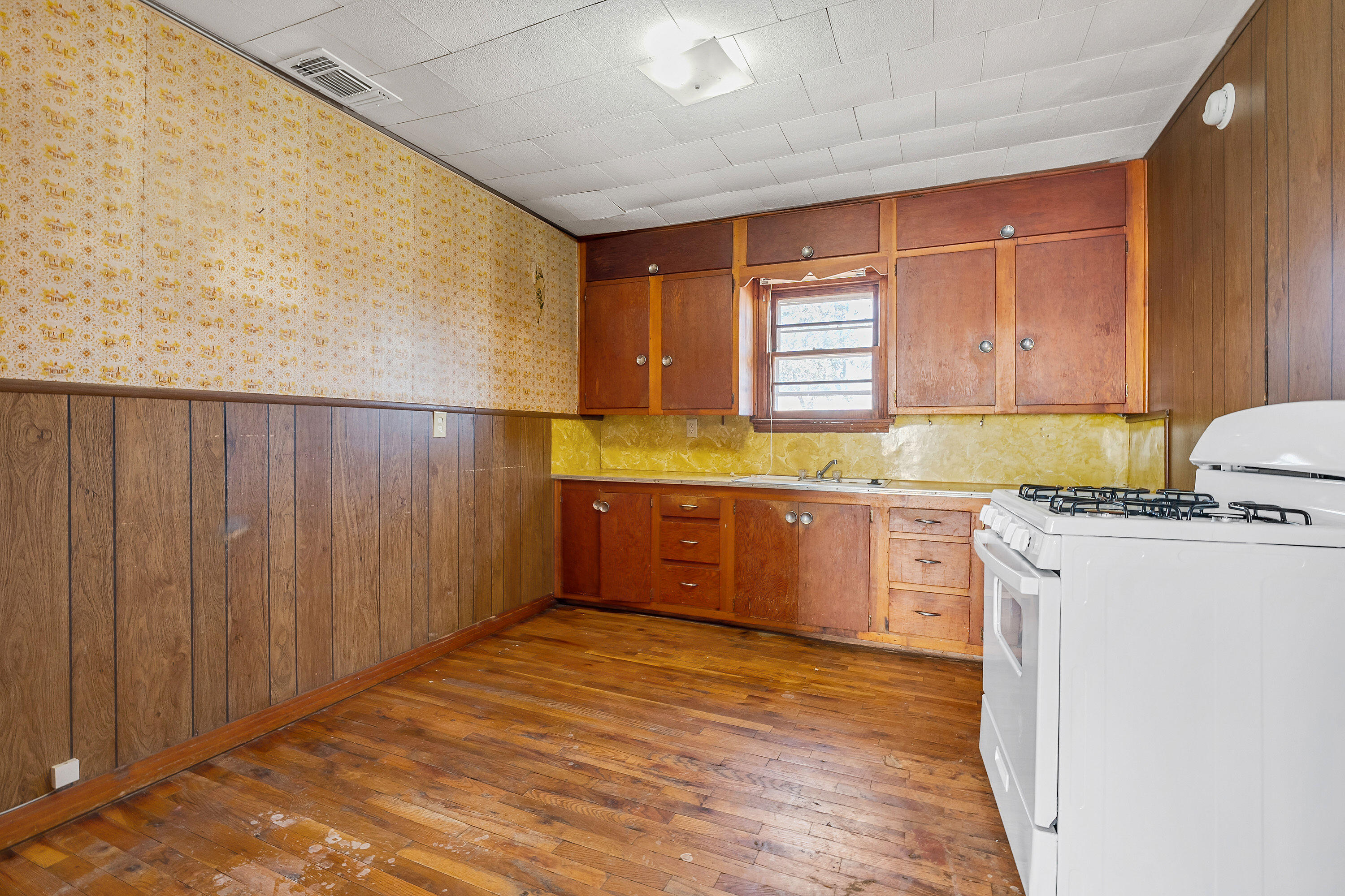 2808 1st Street Lubbock, TX 79415 - Photo 4 of 9 a kitchen with stainless steel appliances granite countertop a sink counter space and wooden floor