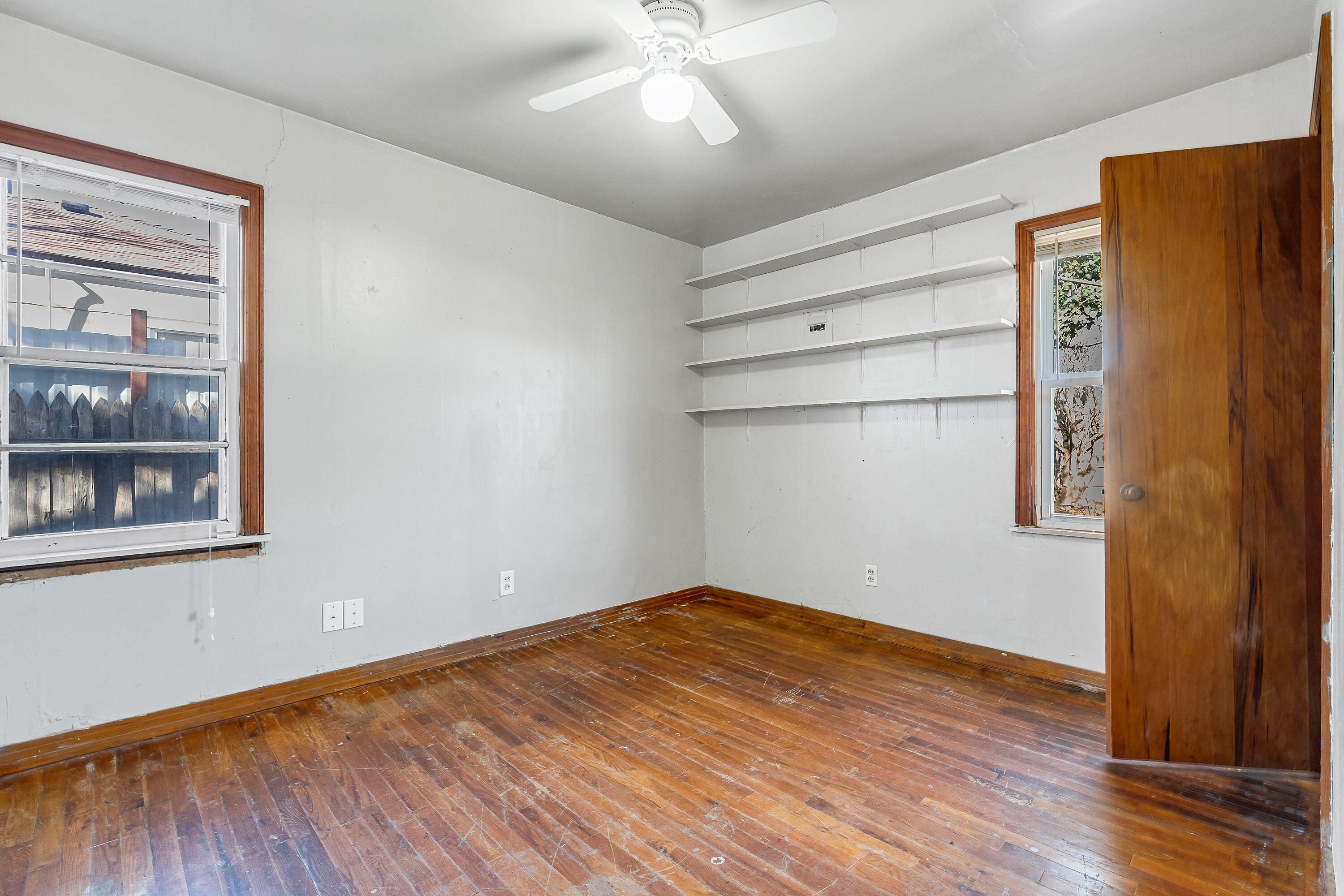 2808 1st Street Lubbock, TX 79415 - Photo 5 of 9 a view of empty room with wooden floor and fan