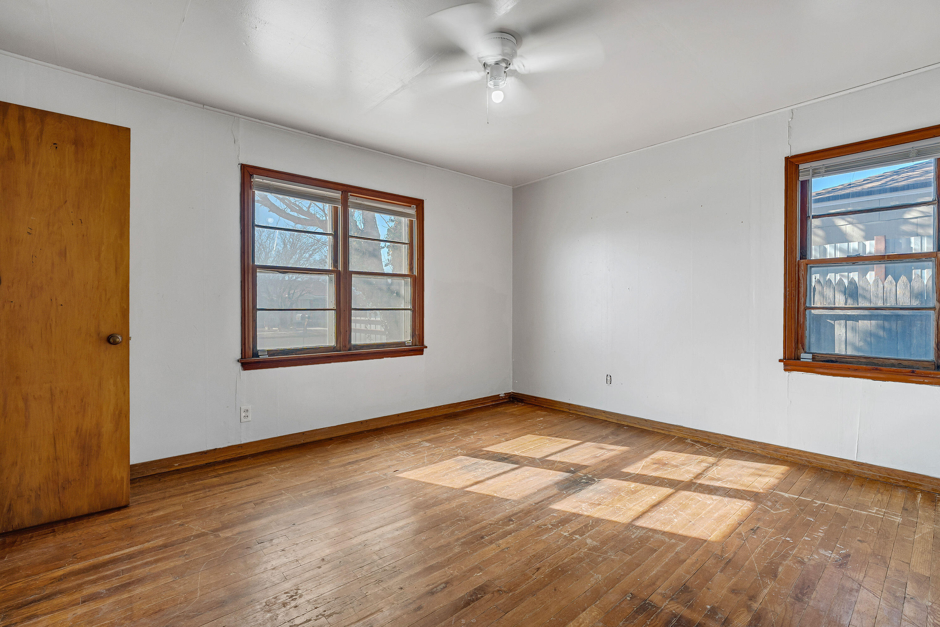 2808 1st Street Lubbock, TX 79415 - Photo 6 of 9 a view of an empty room with window and wooden floor