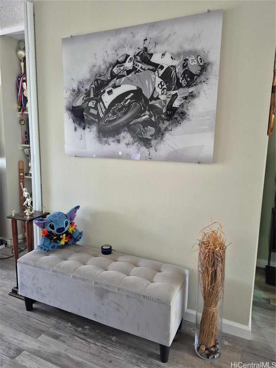 469 Ena Road, Unit 2810 Honolulu, HI 96815 - Photo 1 of 15 a bedroom with a bed and wooden floor