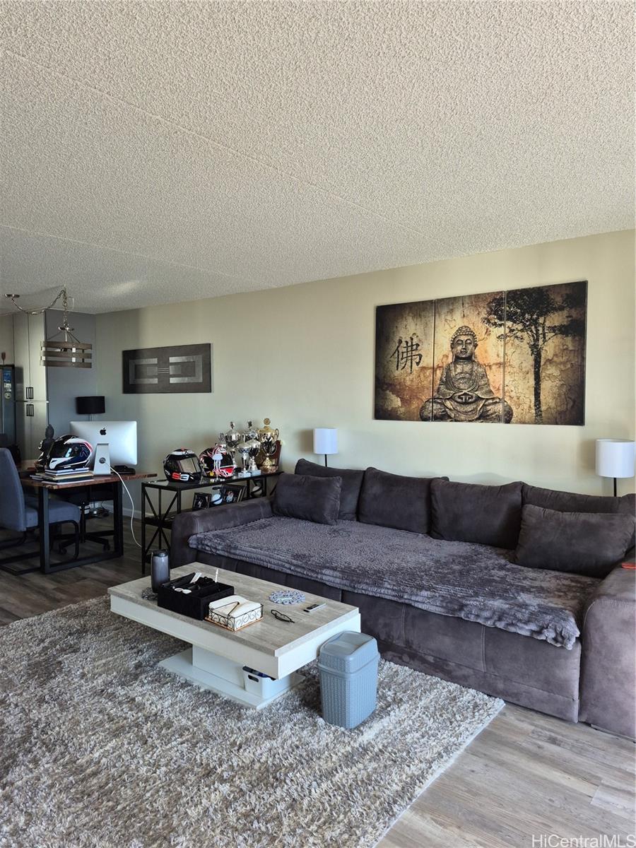 469 Ena Road, Unit 2810 Honolulu, HI 96815 - Photo 6 of 15 a living room with furniture and a rug