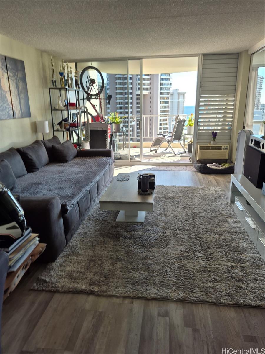469 Ena Road, Unit 2810 Honolulu, HI 96815 - Photo 7 of 15 a living room with furniture and a large window