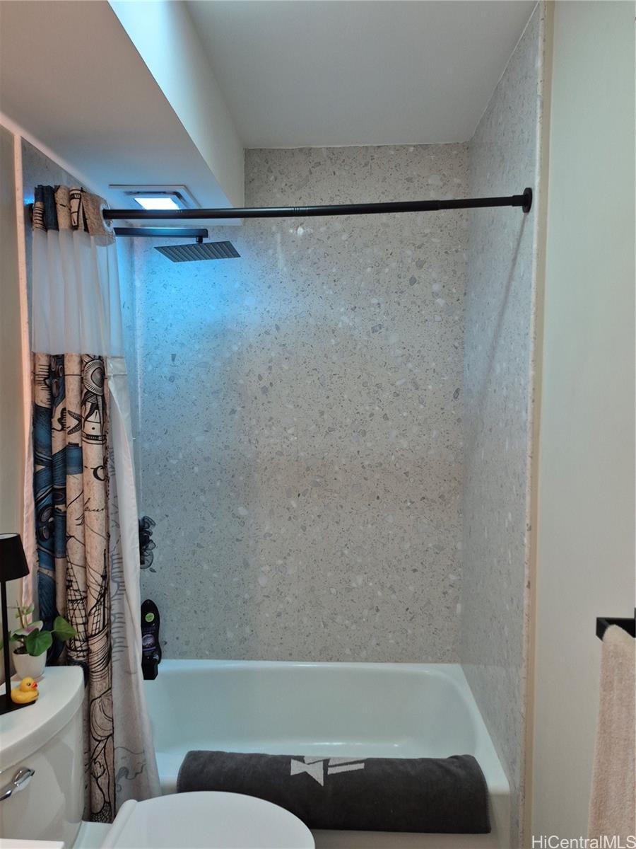 469 Ena Road, Unit 2810 Honolulu, HI 96815 - Photo 9 of 15 a bathroom with a bathtub and a shower