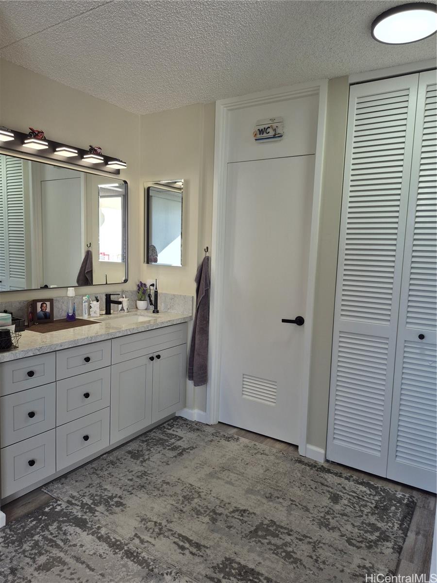 469 Ena Road, Unit 2810 Honolulu, HI 96815 - Photo 10 of 15 a bathroom with a granite countertop sink mirror and a