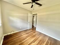 138 Shady Lane Crestview, FL 32536 - Photo 8 of 10 en empty room with wooden floor and fan