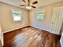 138 Shady Lane Crestview, FL 32536 - Photo 9 of 10 a view of an empty room with wooden floor and a window