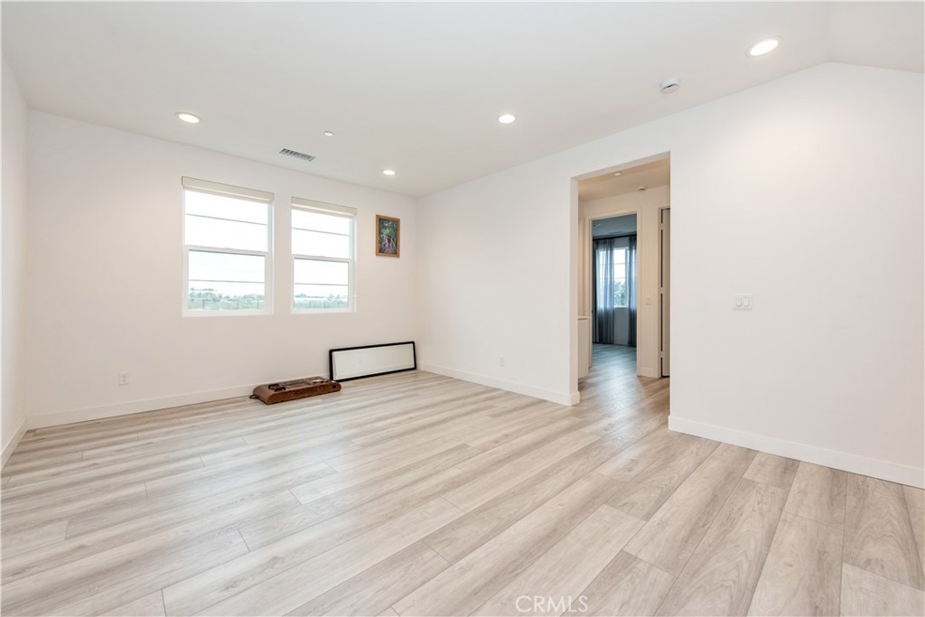 163 Restore Irvine, CA 92618 - Photo 11 of 45 an empty room with wooden floor and windows