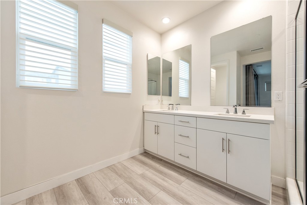 163 Restore Irvine, CA 92618 - Photo 14 of 45 a bathroom with 2 sink tub and a mirror
