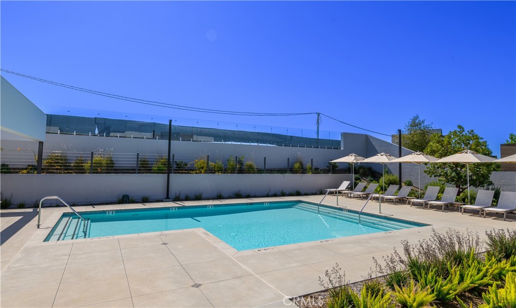 163 Restore Irvine, CA 92618 - Photo 37 of 45 a view of a patio with a table and chairs under an umbrella