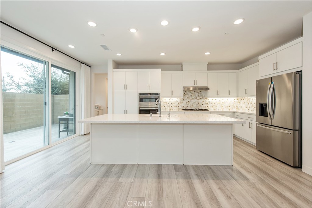 163 Restore Irvine, CA 92618 - Photo 5 of 45 a kitchen with stainless steel appliances granite countertop a refrigerator and a stove top oven