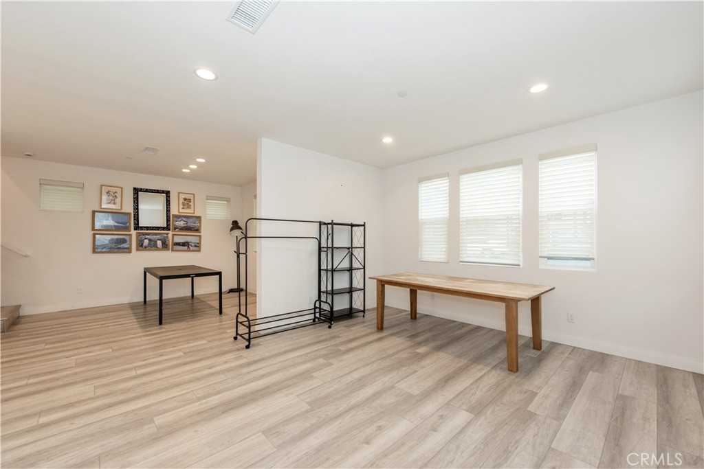 163 Restore Irvine, CA 92618 - Photo 7 of 45 a view of a living room filled with furniture and a wooden floor