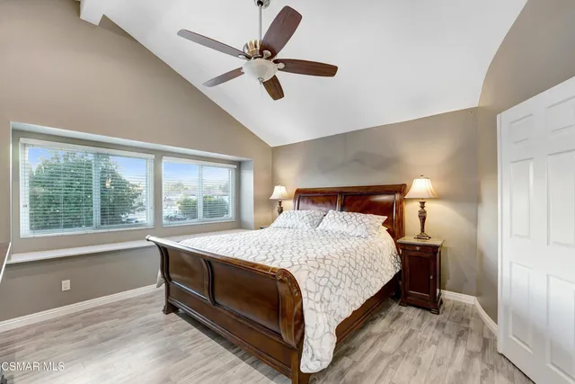 a bed sitting in a bedroom next to a window