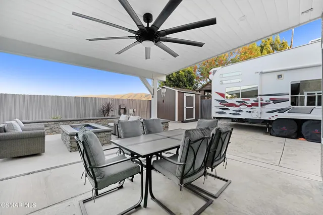 a dining room with furniture and a ceiling fan