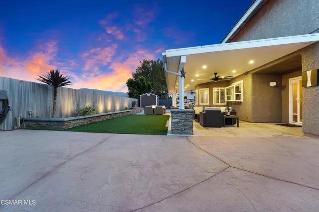 a view of a house with a backyard