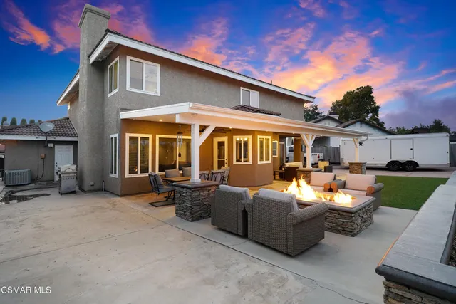 a patio with sofas table and chairs
