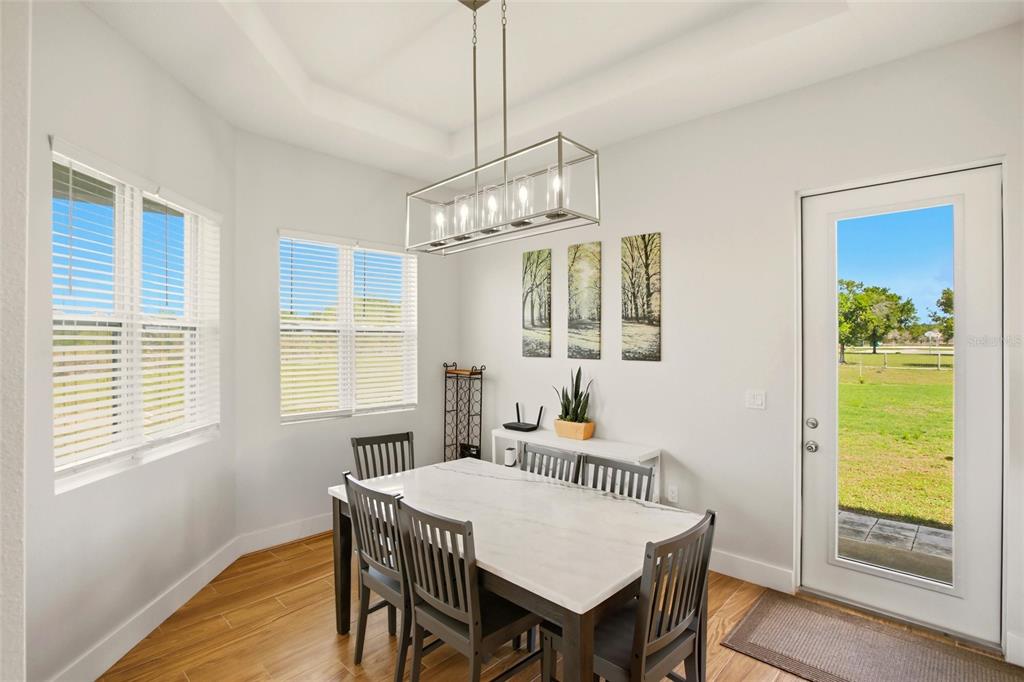 10080 Wauchula Road Myakka City, FL 34251 - Photo 16 of 55 a view of a dining room with furniture window and wooden floor