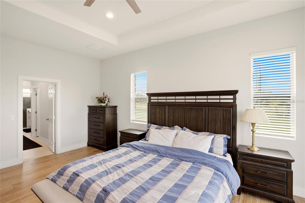 10080 Wauchula Road Myakka City, FL 34251 - Photo 20 of 55 a bedroom with a bed and a chandelier