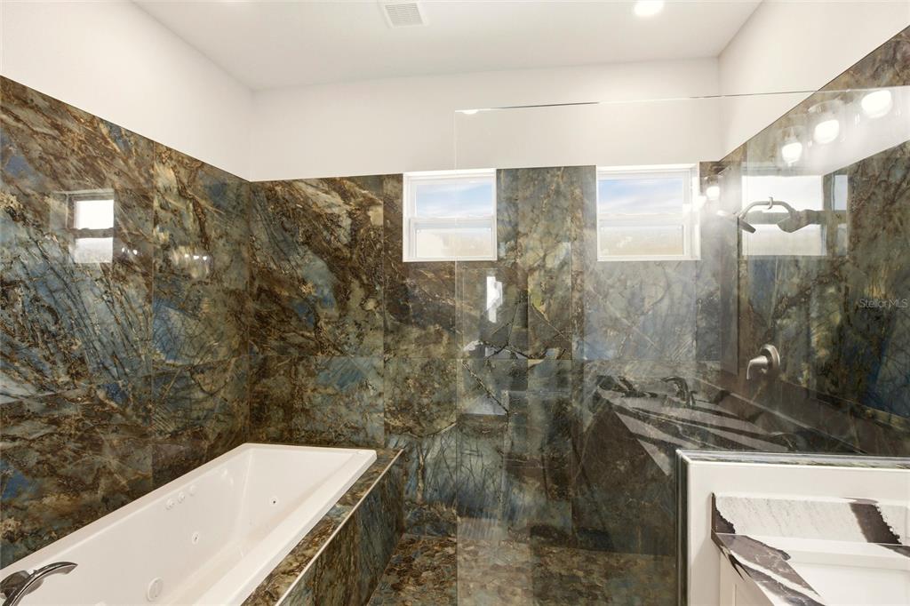 10080 Wauchula Road Myakka City, FL 34251 - Photo 24 of 55 a bathroom with a granite countertop sink a toilet and shower