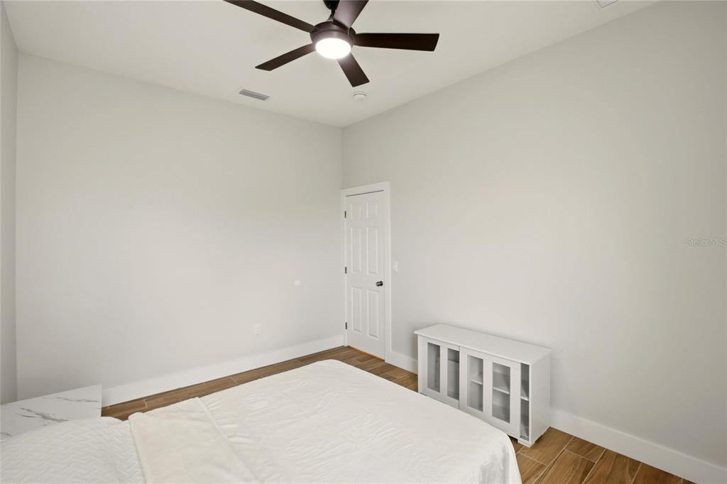 10080 Wauchula Road Myakka City, FL 34251 - Photo 33 of 55 a bedroom with a bed and a chandelier fan