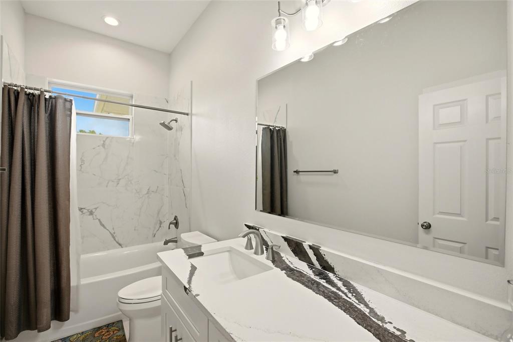 10080 Wauchula Road Myakka City, FL 34251 - Photo 34 of 55 a bathroom with a granite countertop bathtub shower sink vanity and toilet