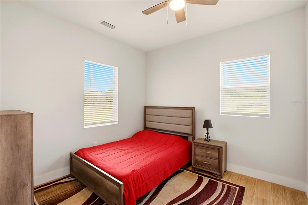 10080 Wauchula Road Myakka City, FL 34251 - Photo 36 of 55 a bedroom with a bed and a chandelier