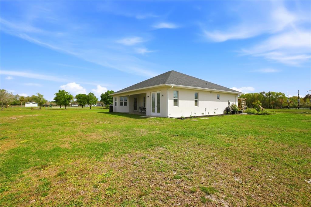 10080 Wauchula Road Myakka City, FL 34251 - Photo 44 of 55 a big house with green field in front of it
