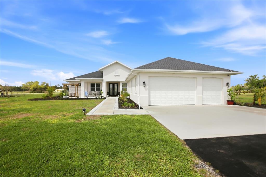 10080 Wauchula Road Myakka City, FL 34251 - Photo 5 of 55 a front view of a house with a yard