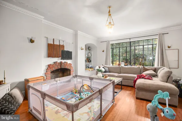a living room with furniture fireplace and a large window