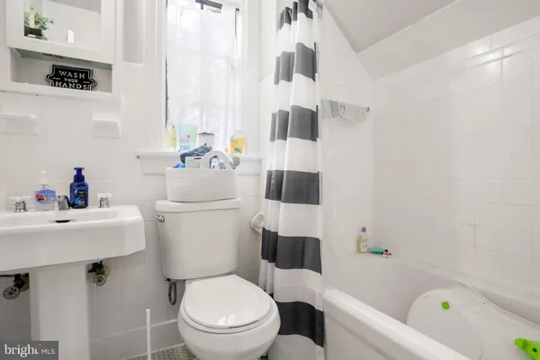 a white toilet sitting next to a bathroom sink