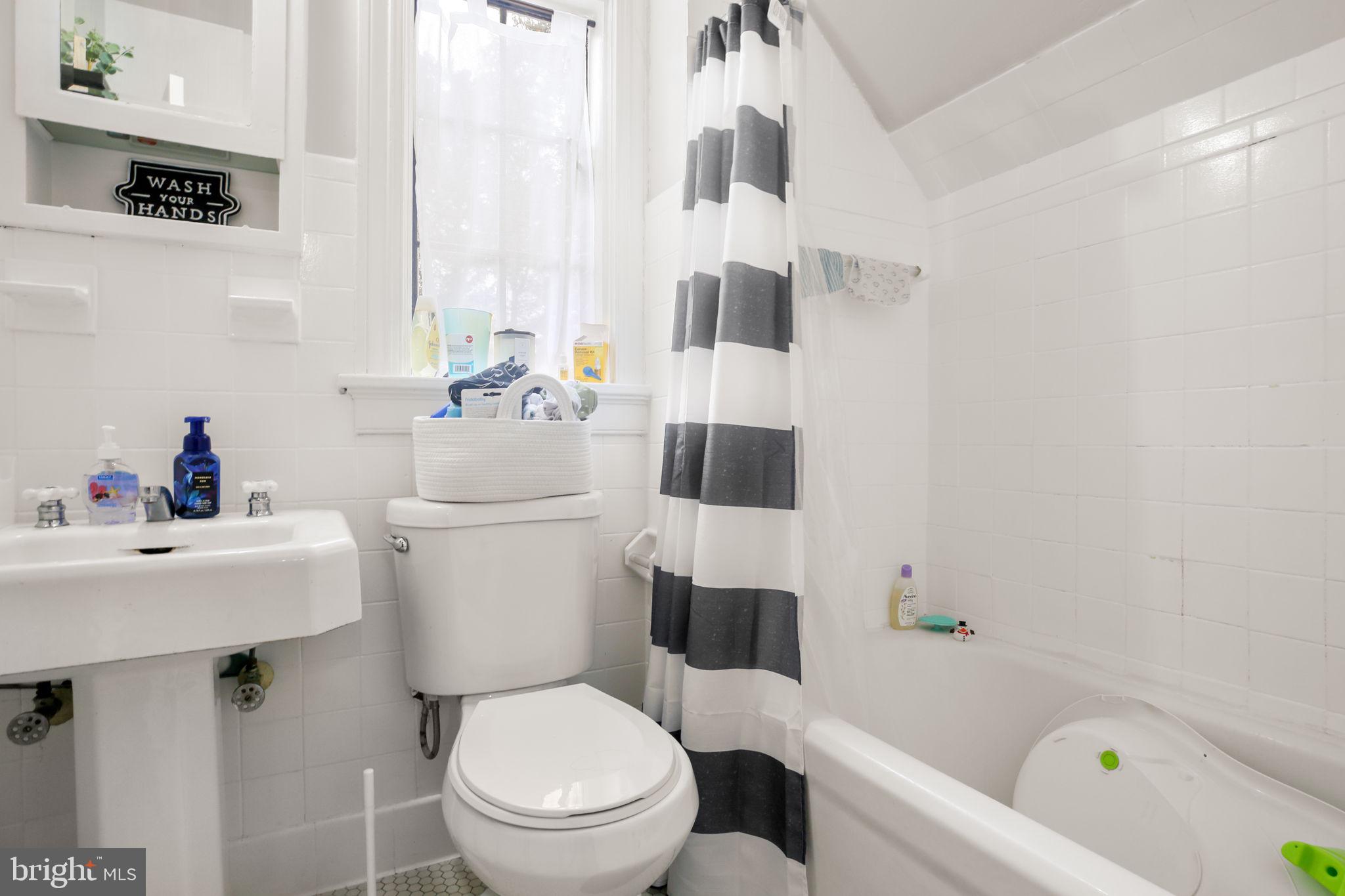 1717 Highland Road Fredericksburg, VA 22401 - Photo 16 of 40 a white toilet sitting next to a bathroom sink