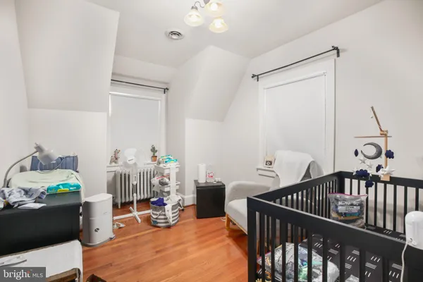 a bedroom with furniture and a wooden floor